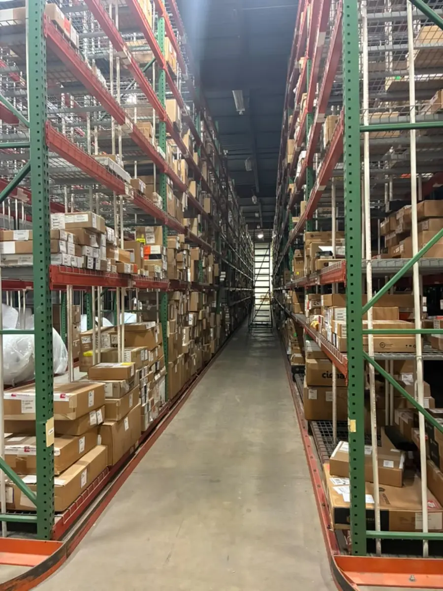 High-bay pallet racking aisle stocked with labeled boxes at the Rush 24/7 warehouse in Philadelphia, PA