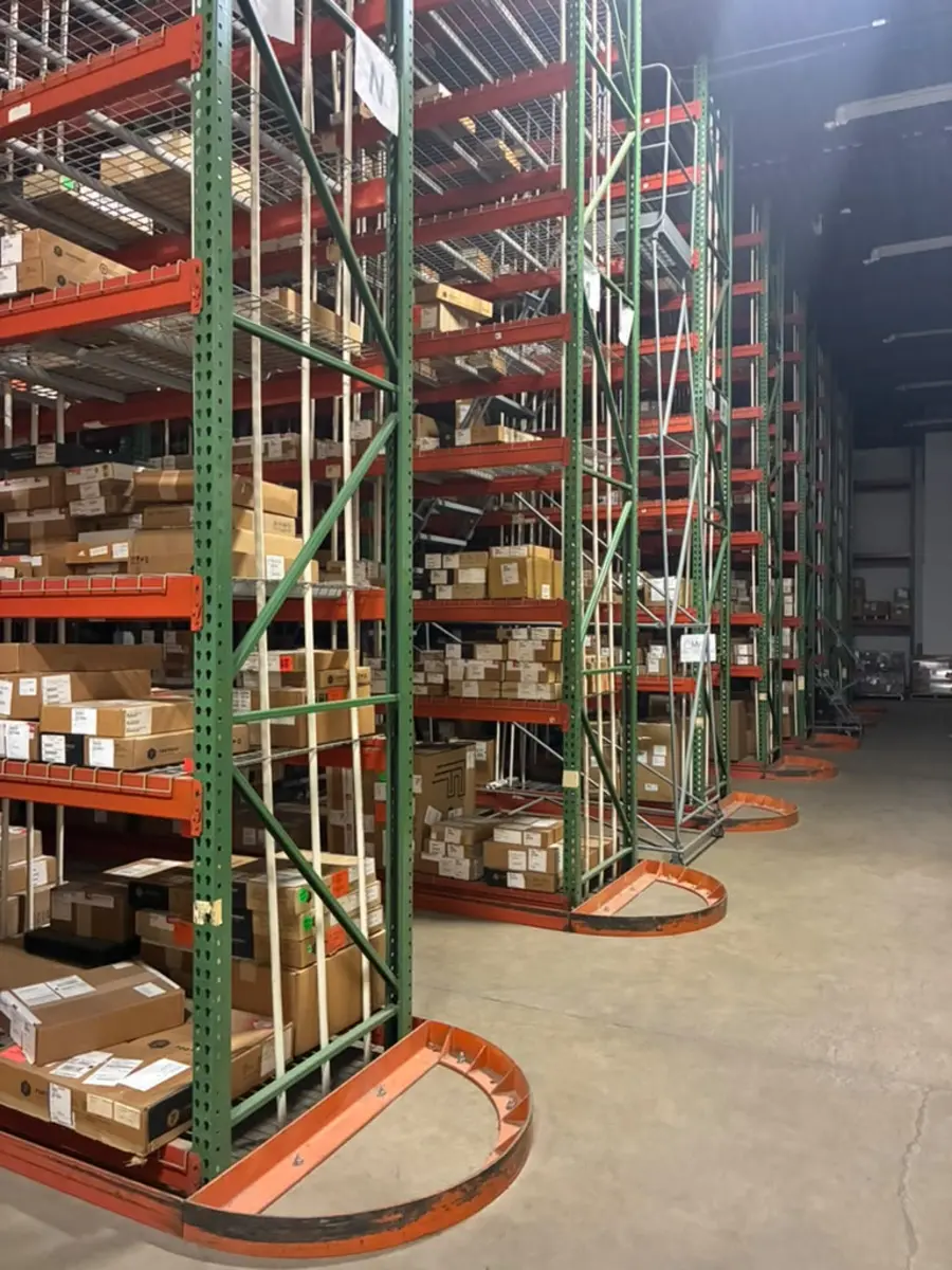 Rows of organized shelf racking with labeled inventory at the Rush 24/7 warehouse